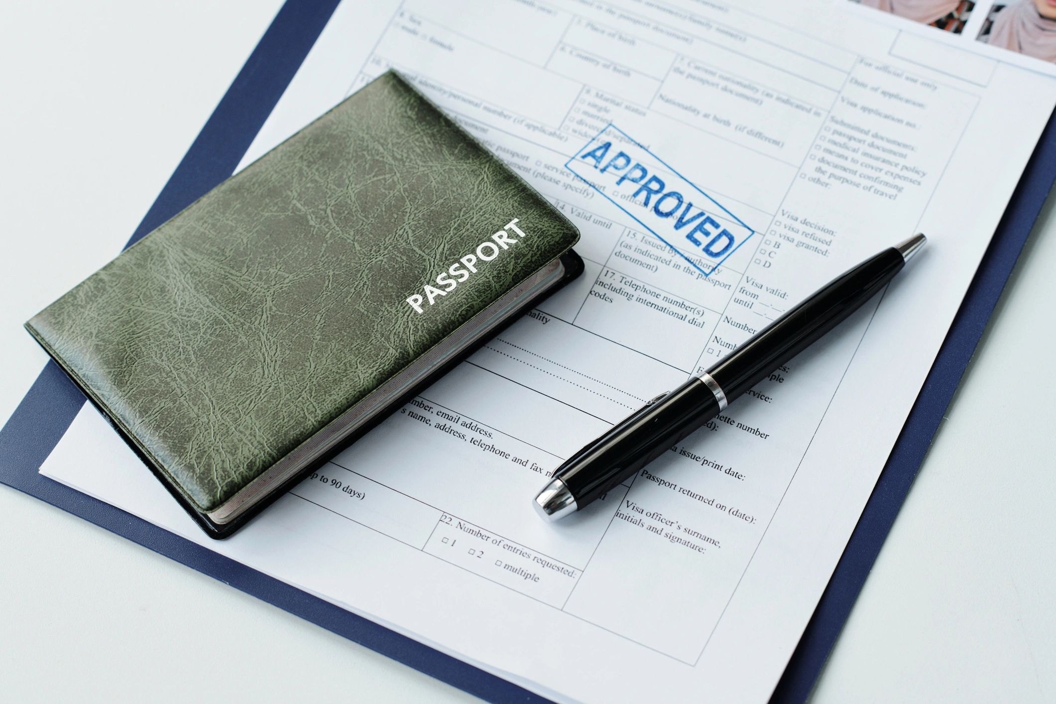 Passport and visa application paperwork on a desk