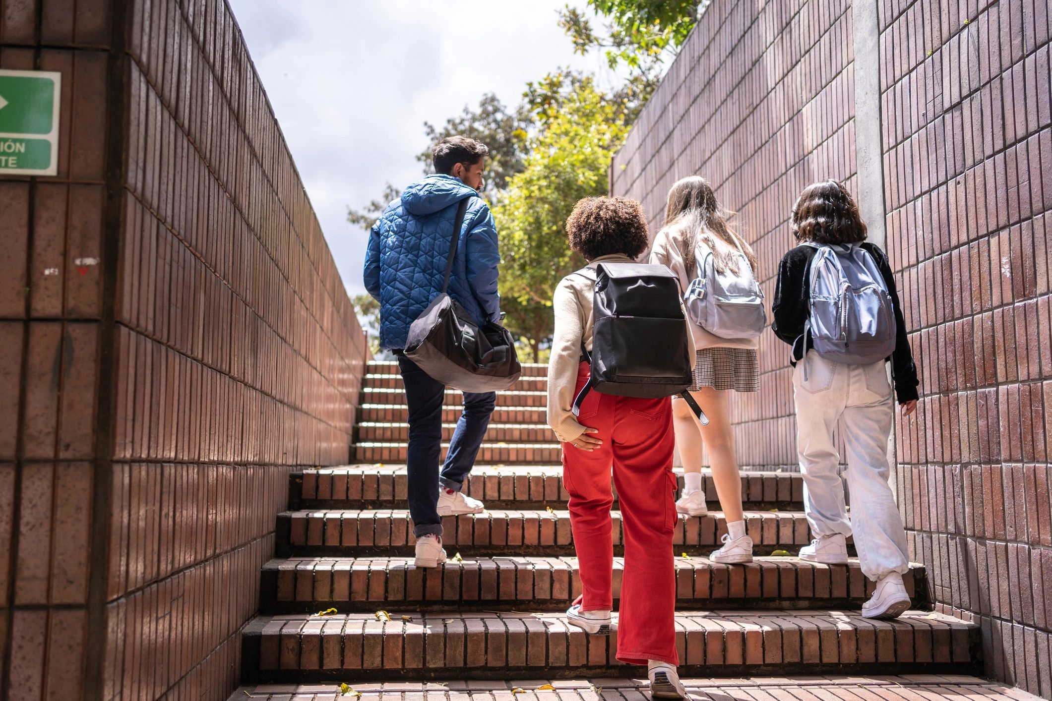 Students walking outdoors on campus stairs