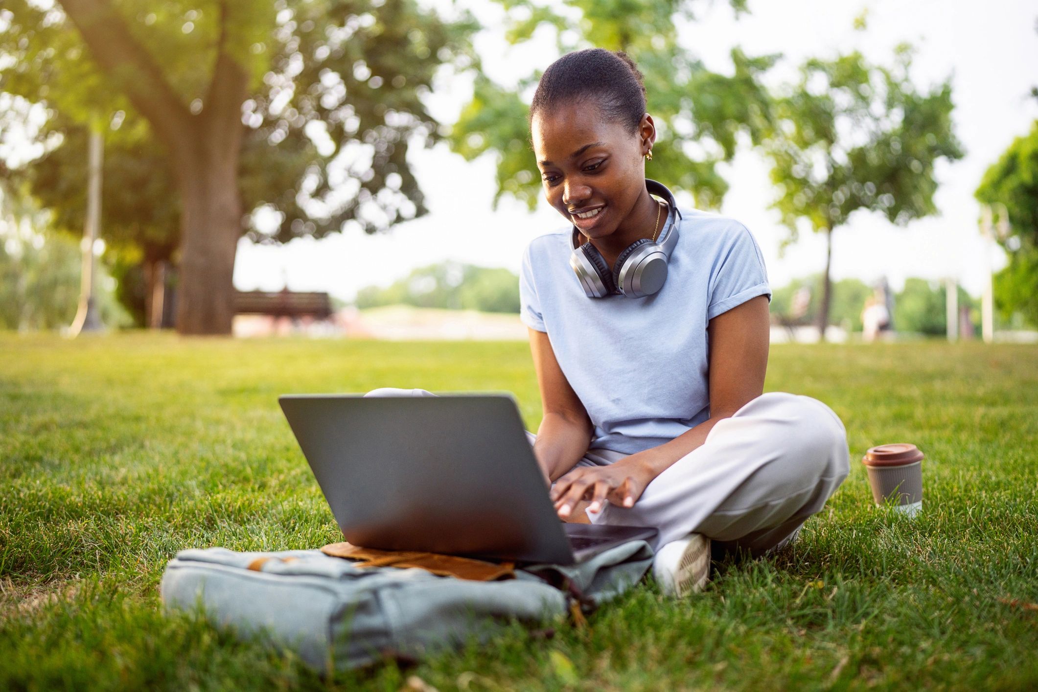 Student working on a laptop outdoors