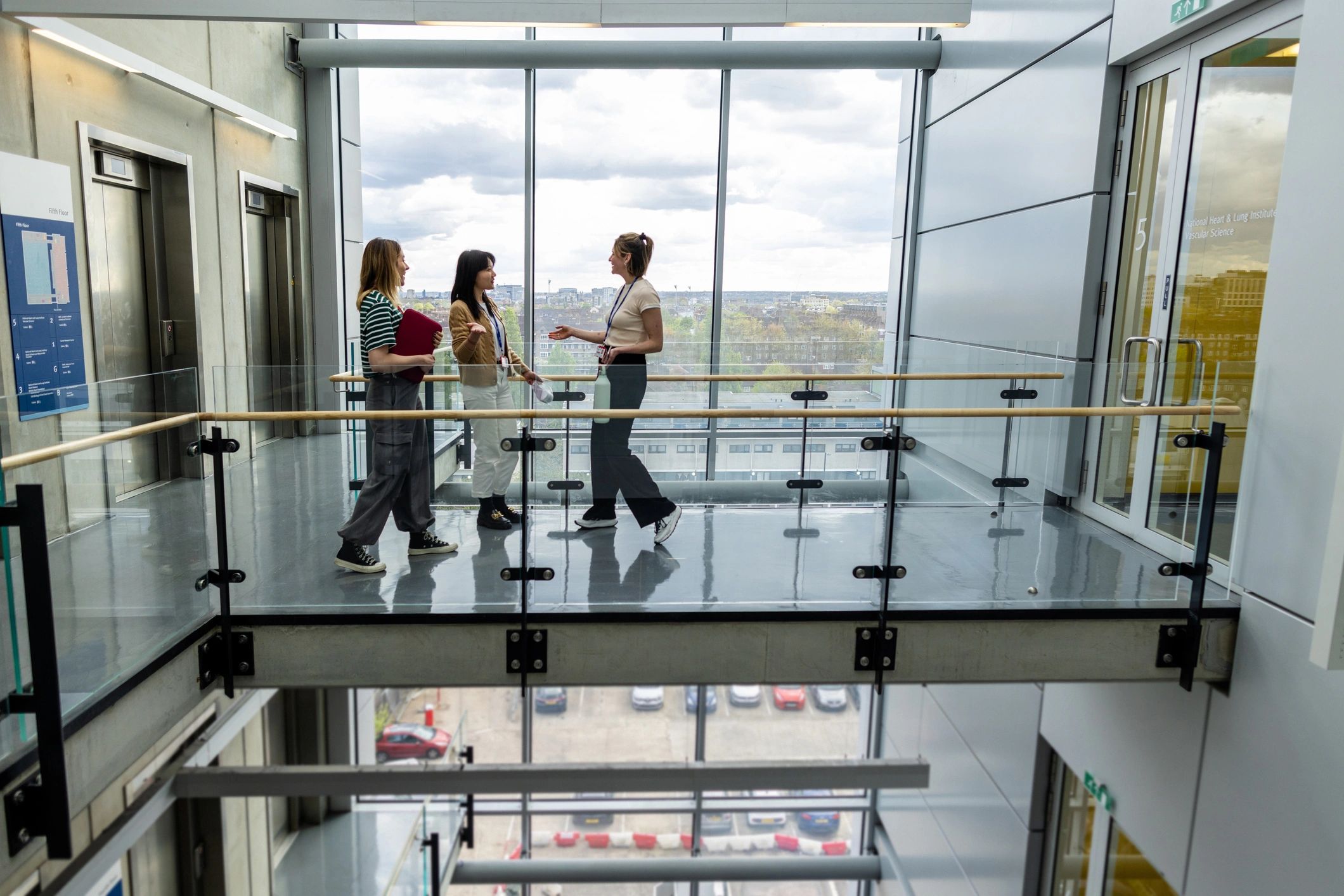 Students walking through a university building corridor